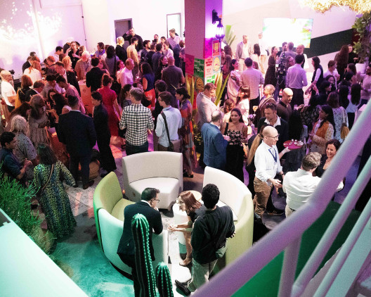 overhead shot of people in a room, celebrating an opening