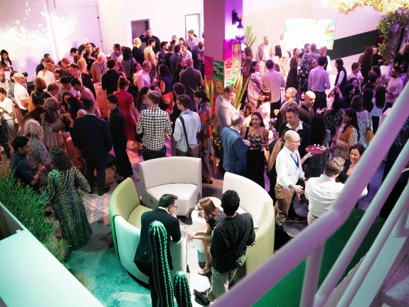 overhead shot of people in a room, celebrating an opening